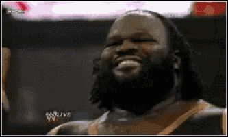 a man with a beard is smiling in front of a sign that says wlive