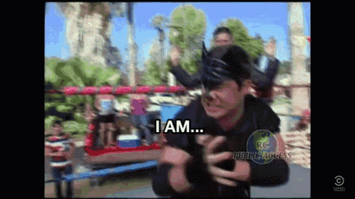 a man in a boxing ring says i am in front of a roller coaster