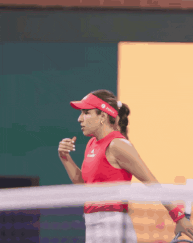 a woman wearing a red tank top and a red visor with a huawei logo on it