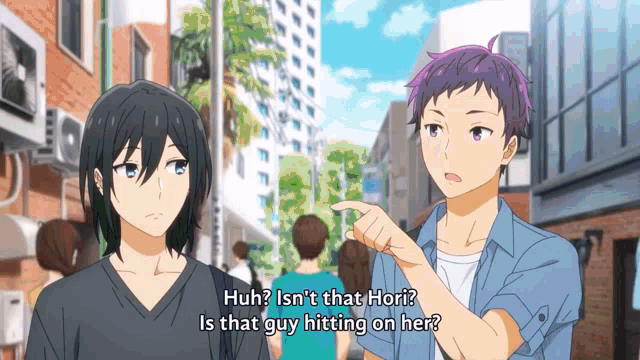 a man with purple hair is pointing at a woman with black hair