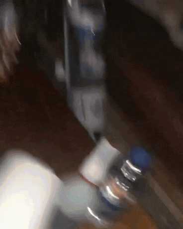 a blurred image of a bottle of water with a blue cap