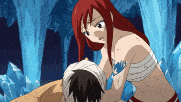 a woman with red hair is holding a man with a bandage around his head