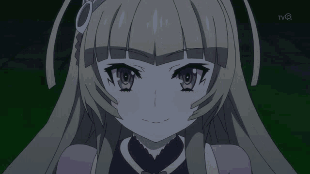 a close up of a girl 's face with the tvq logo in the background