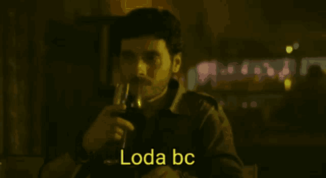a man is holding a glass of wine and says " loda bc " on the bottom