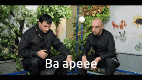 two men sitting next to each other with ba apeee written on the screen
