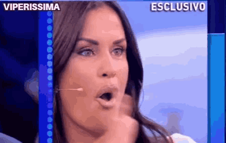 a close up of a woman 's face with her mouth open and the words viperissima behind her