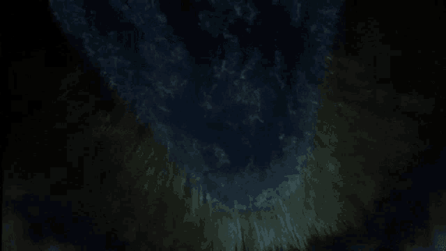looking up at a dark sky with a lot of clouds in it