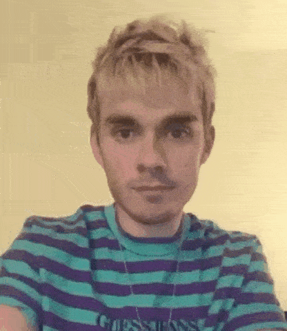 the man is wearing a striped shirt and a necklace .