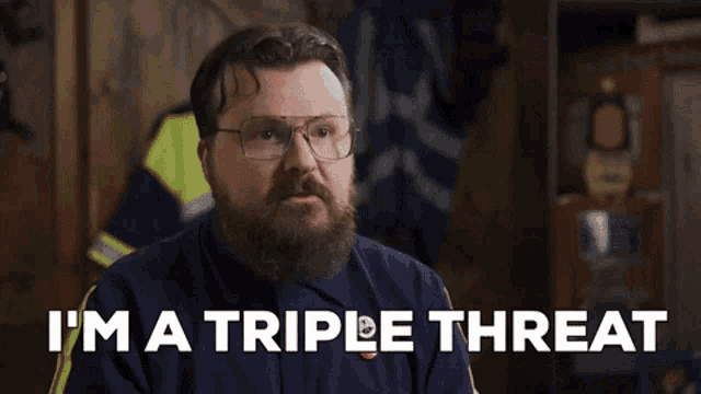 a man with glasses and a beard is saying i 'm a triple threat
