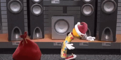 a cartoon character is dancing in front of a speaker .