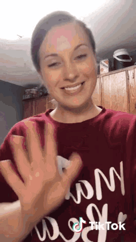 a woman wearing a red shirt with mom on it