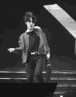 a black and white photo of a man on a stage