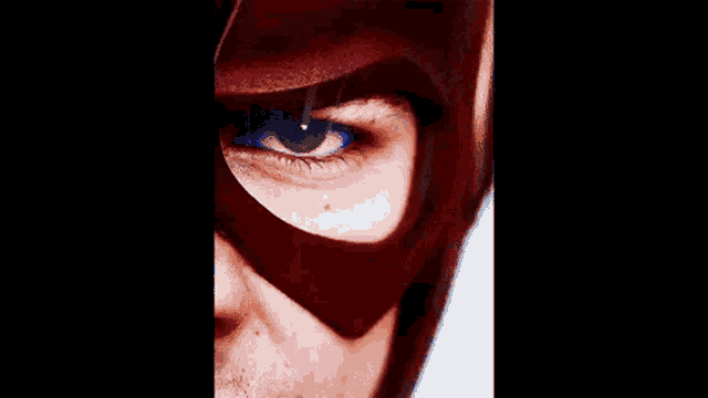 a close up of a person 's eye with a red mask on