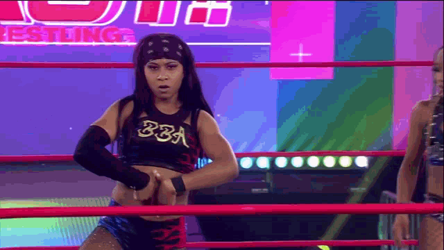 a woman in a wrestling ring wearing a bra
