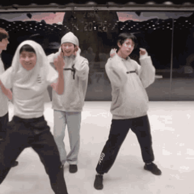 a group of people are dancing in front of a clock that shows 20:22