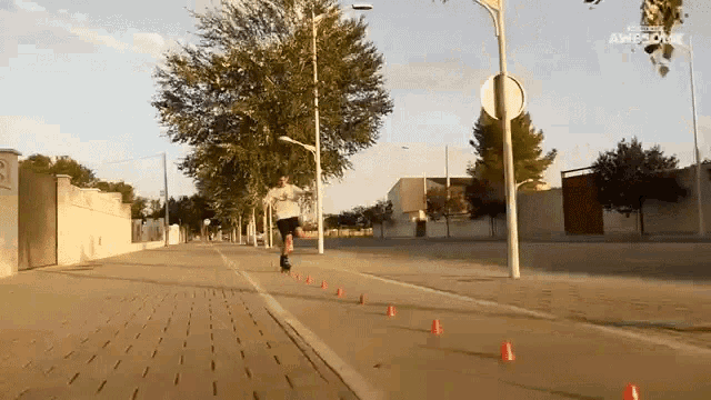 a man is rollerblading down a sidewalk with a sign that says " amprove " on it