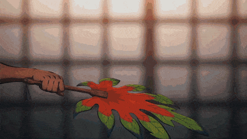 a person is holding a plant with leaves on it