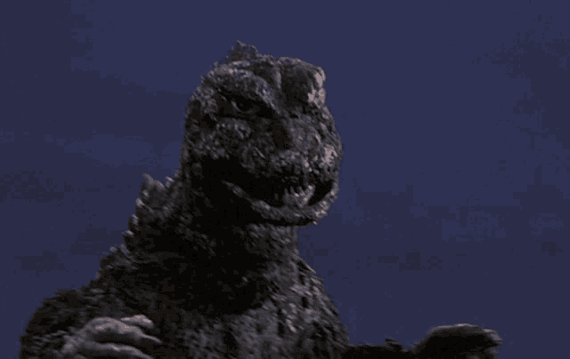 a statue of a monster against a blue sky