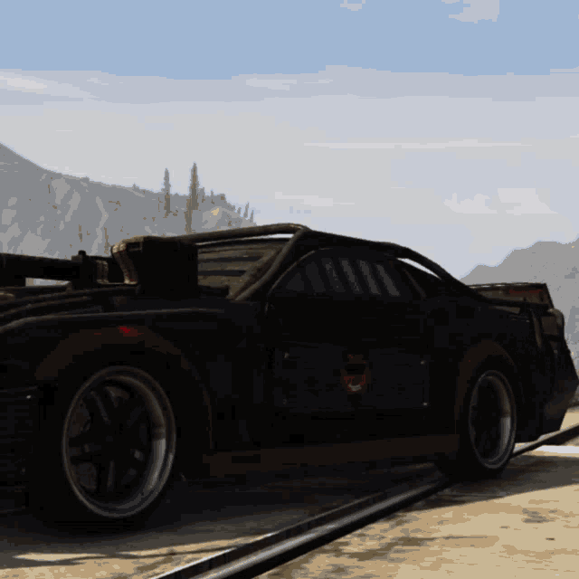 a black car with a red stripe on the side is parked on the side of a road