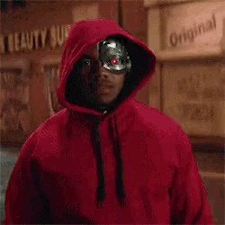 a man wearing a red hoodie with a robot mask on his face