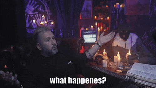 a man sitting at a table with candles and the words " what happenes " above him