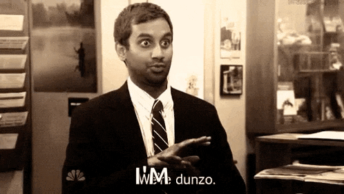 a man in a suit and tie is making a funny face and says i 'm dunzo .