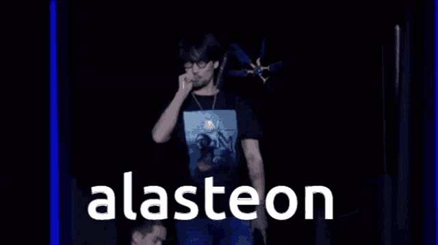a man is standing in front of a sign that says alasteen .