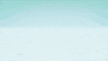 a person standing in front of a cloudy sky with a light coming out of the sky