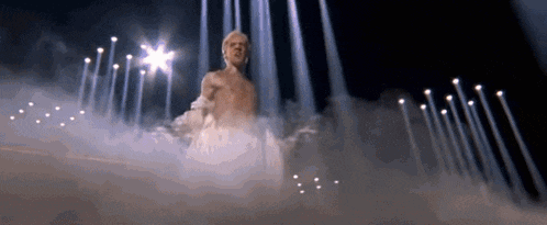 a man is standing in front of a row of lights .