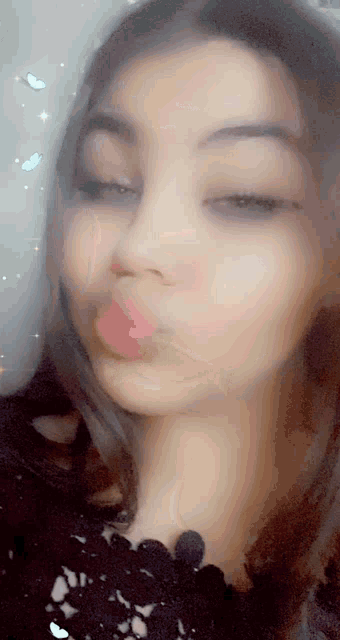 a close up of a woman 's face with pink lipstick on her lips