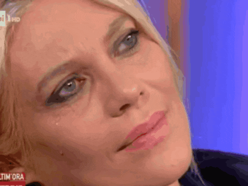 a close up of a woman 's face with the word tim on the bottom left