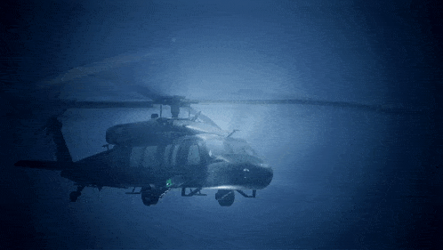 a helicopter is flying in the dark with a green light on the side