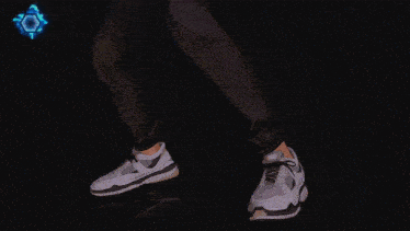 a person is doing a handstand in a dark room