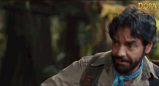 a man with a blue bandana around his neck is in a movie called dora the lost city of gold