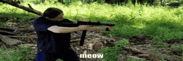 a man in a blue shirt is holding a gun and the word meow is on the bottom right