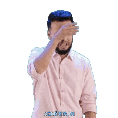 a man wearing a pink shirt has the word comicstaan on his shirt
