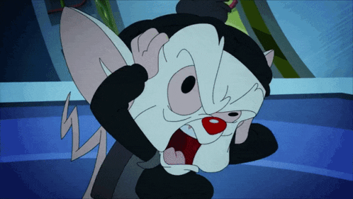 a cartoon mouse with a black hat is covering his face with his hand