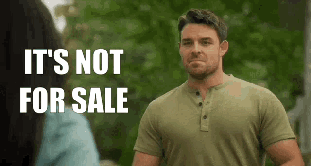 a man in a green shirt is standing in front of a woman and saying `` it 's not for sale '' .