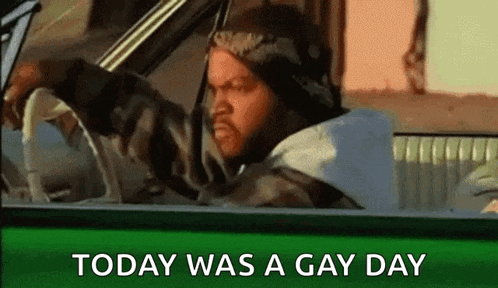 ice cube is driving a car with the words `` today was a gay day '' on the screen .