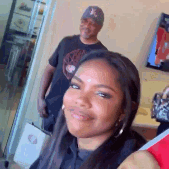 a man is standing next to a woman in a room .