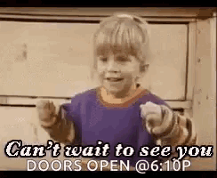 a little girl is pointing at the camera and saying `` can 't wait to see you doors open @ 6:10p '' .