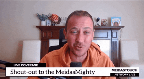 a man speaking into a microphone with shout-out to the meidas mighty written on the bottom