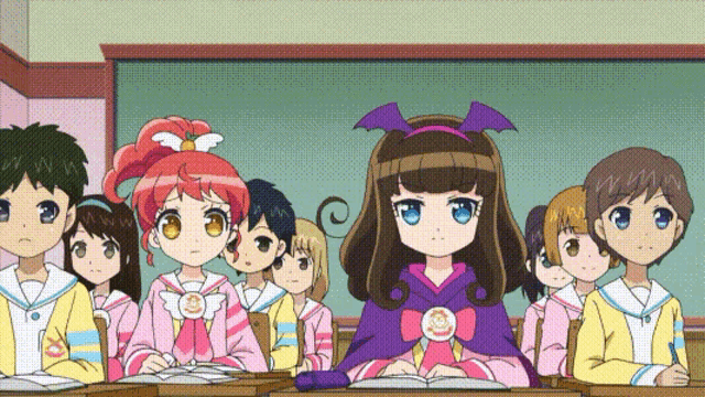a group of children are sitting in a classroom with one girl wearing a bat costume