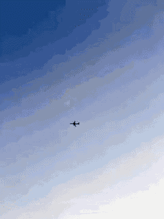 a small airplane is flying through a blue sky