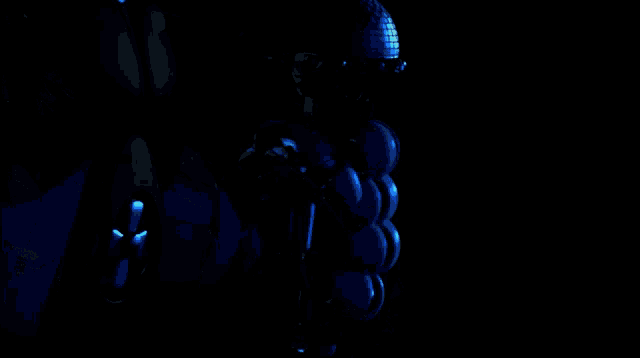 a robotic arm is holding a microphone in a dark room