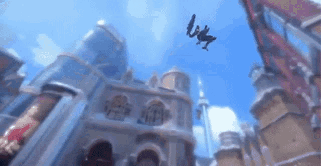 a man is flying through the air in front of a castle .