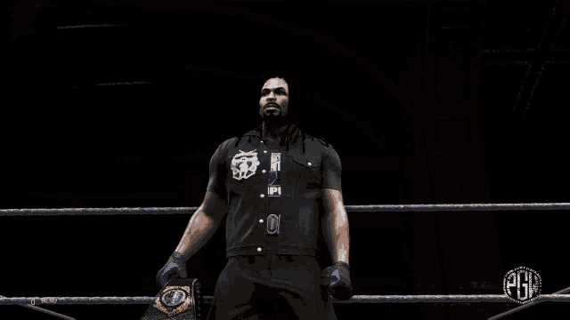 a man in a black shirt is holding a wrestling championship belt in a ring