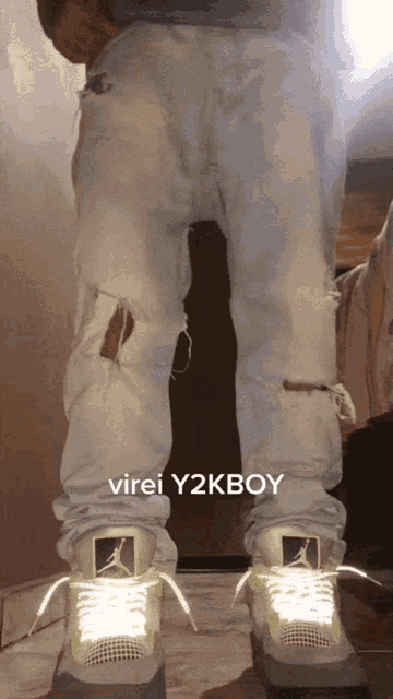 a person wearing dirty jeans and jordan shoes with virei y2kboy written in the corner