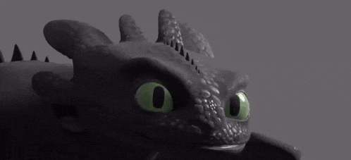 toothless from how to train your dragon is looking at the camera with green eyes .