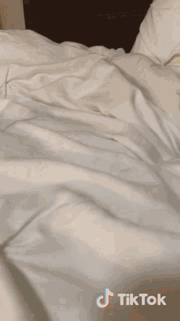 a cup of ben & jerry ice cream on a bed